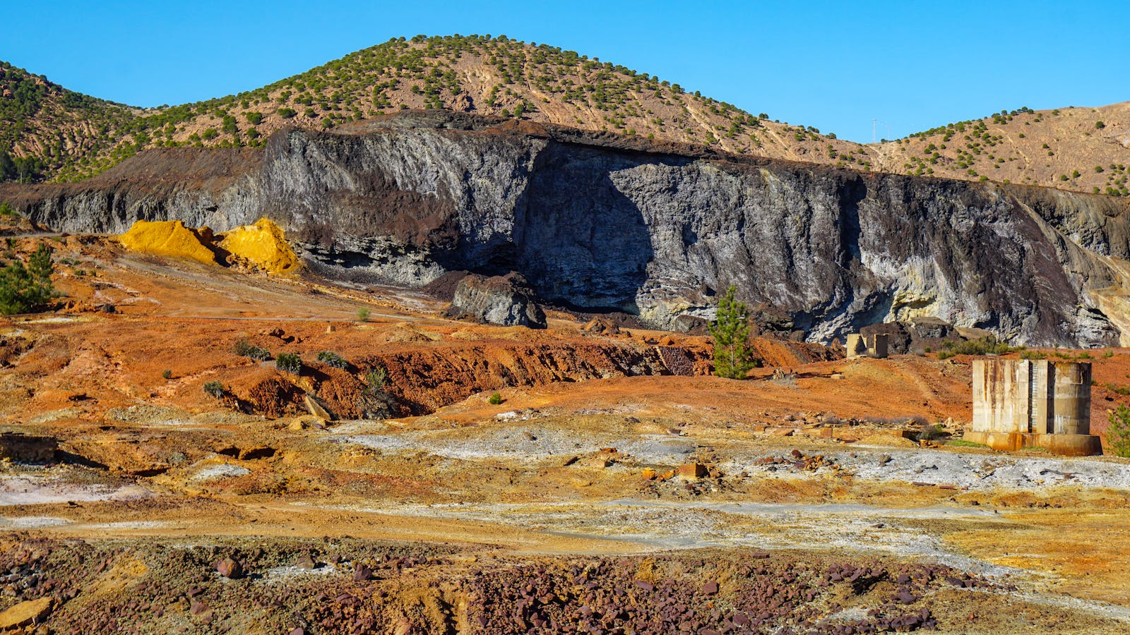 Rugged mining landscape with exposed mineral deposits and old workings
