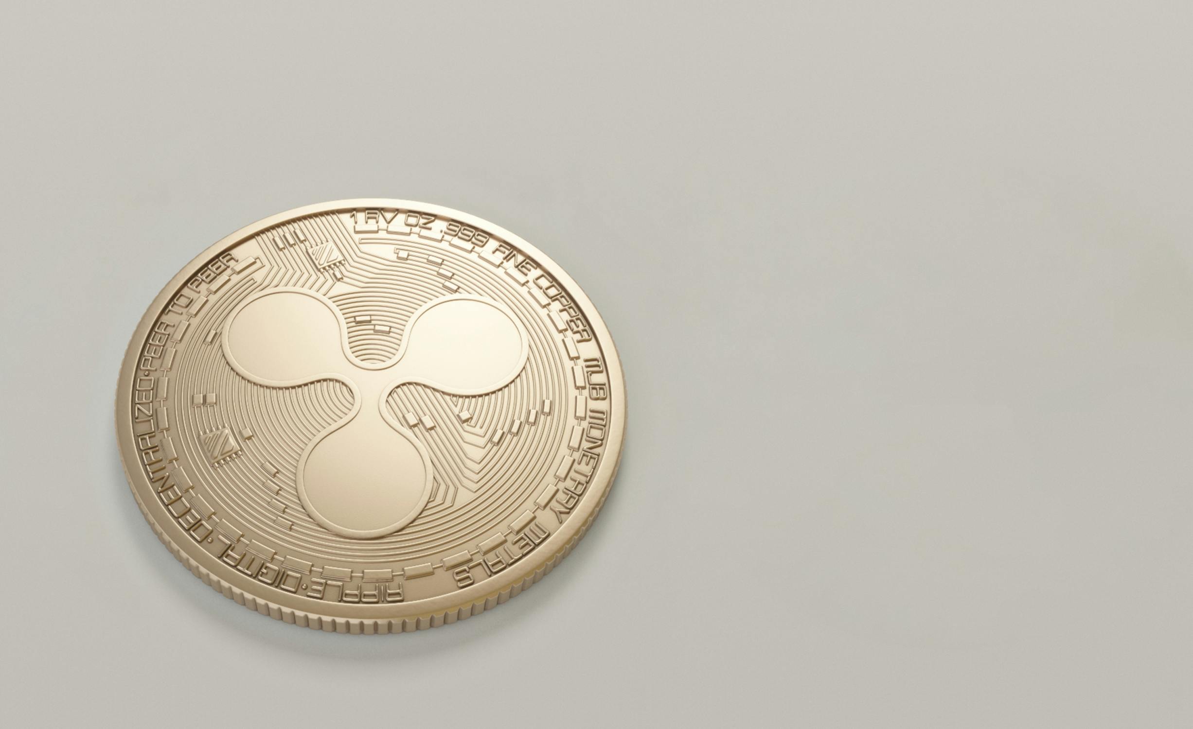 Golden XRP cryptocurrency coins on a laptop keyboard representing cross-border payments