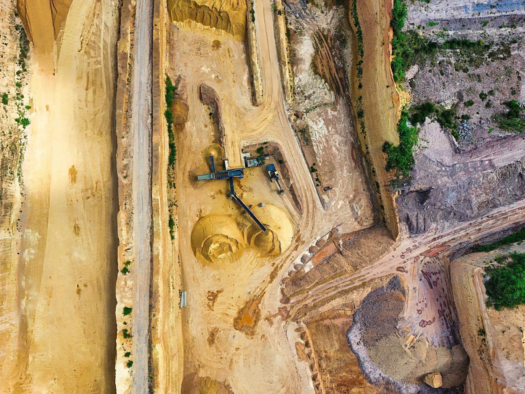 Aerial view of an open-pit mining site with processing equipment