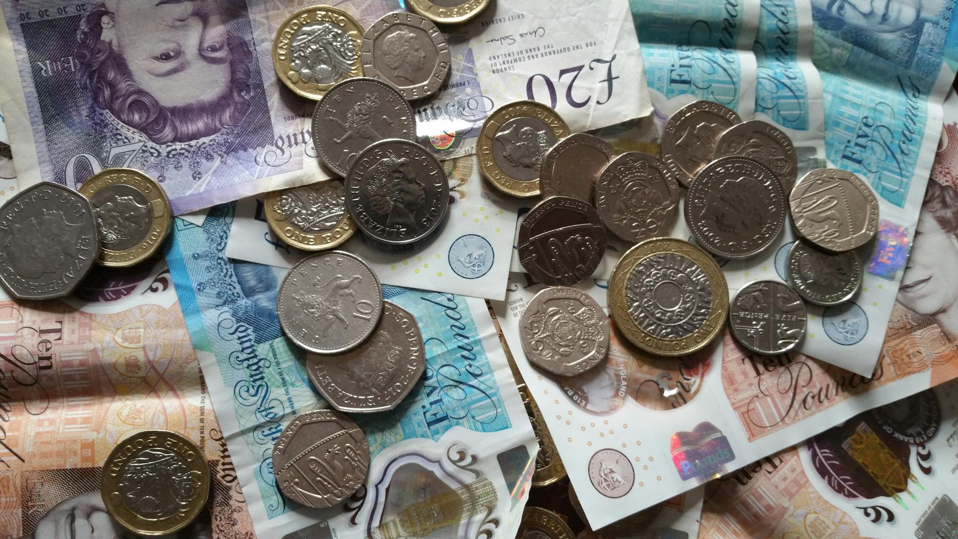 British pound coins and banknotes representing UK investment and savings