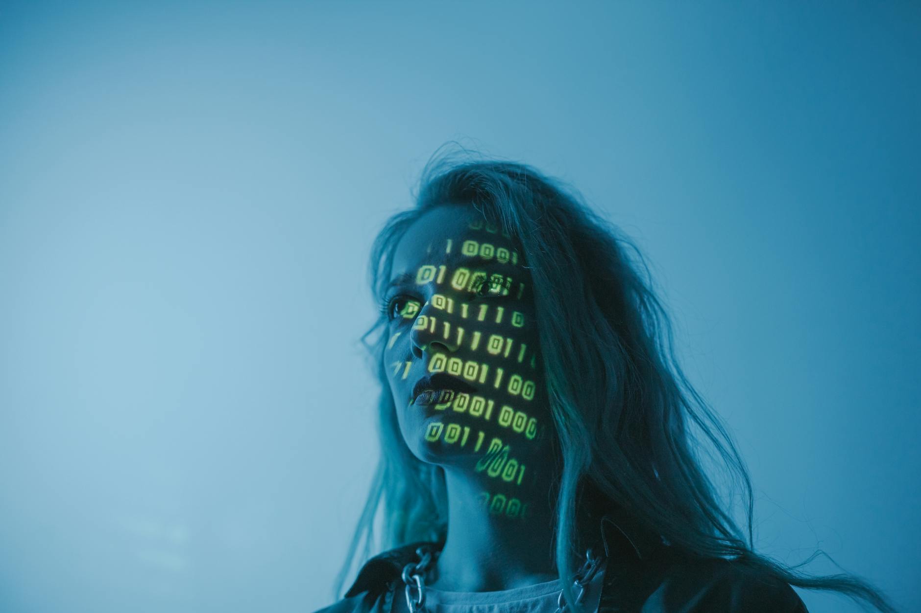 Person working at a computer in a dark studio environment representing AI and technology work