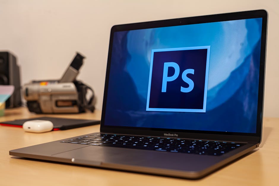 Designer working at a laptop with creative software open