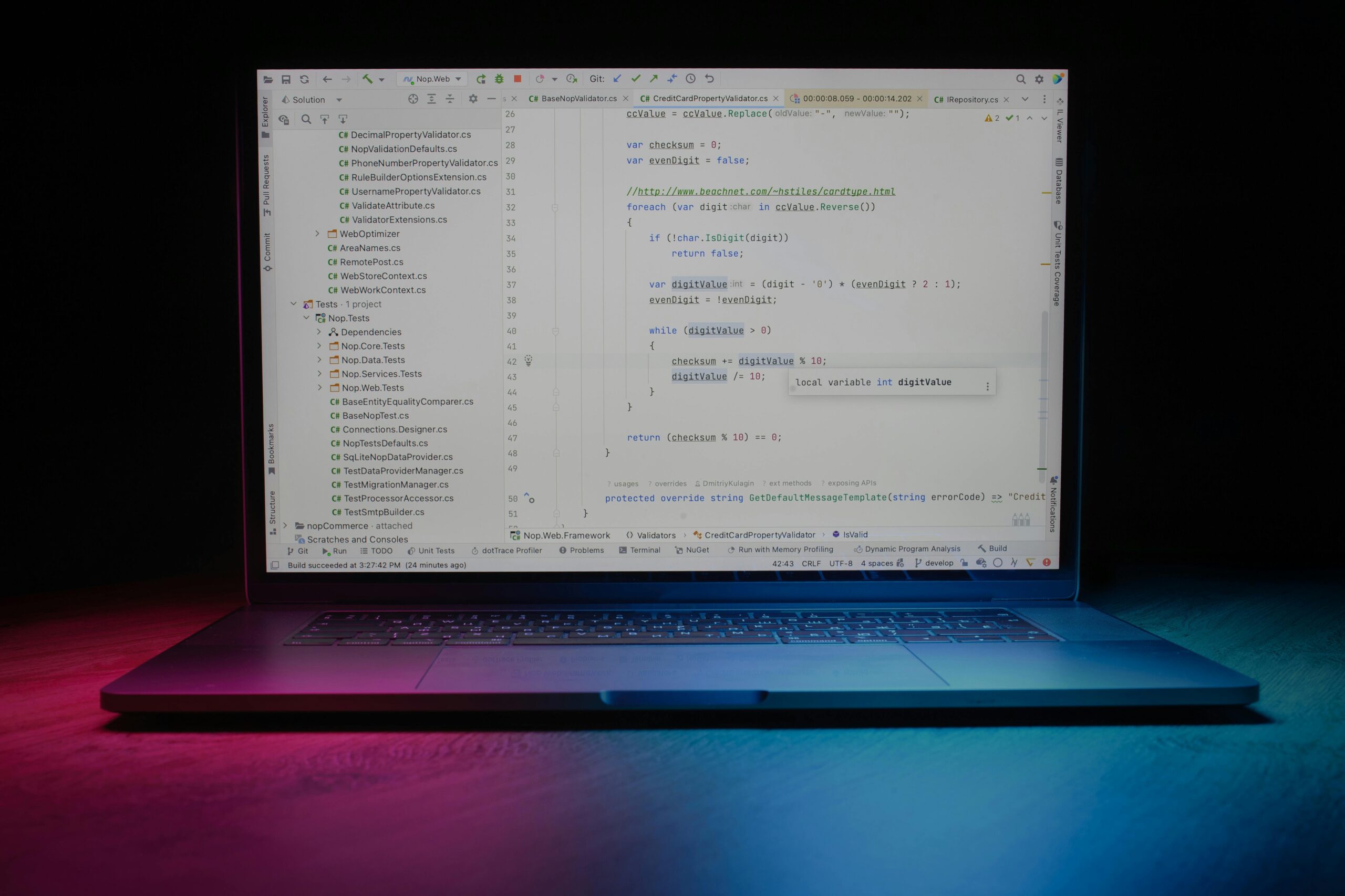 Developer at laptop working with code, representing AI-assisted software development