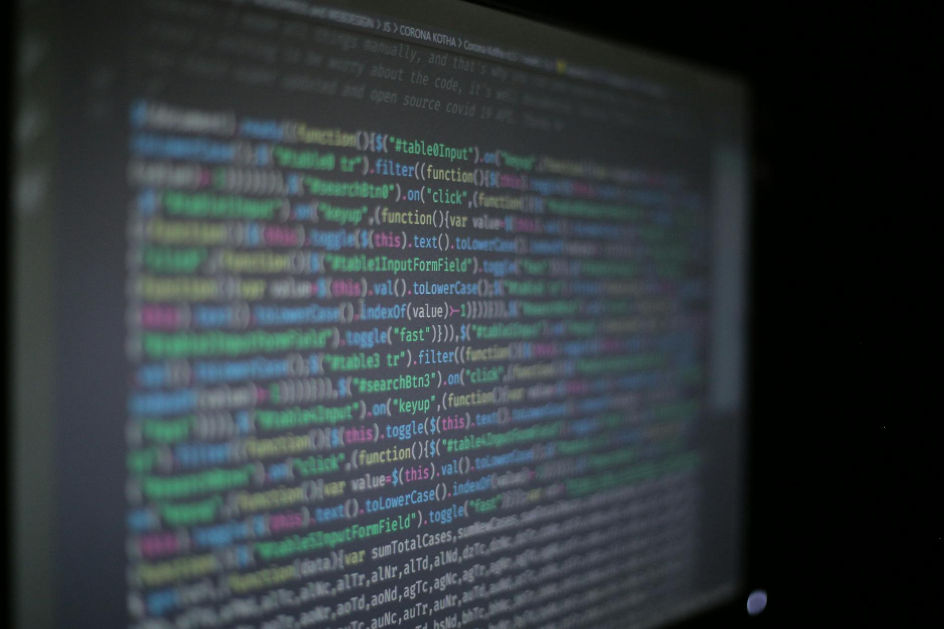 Lines of code on a monitor representing cybersecurity analysis and vulnerability research