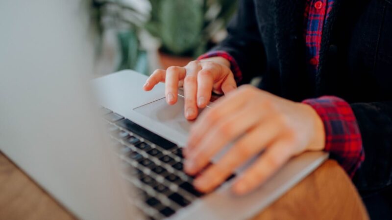 Person typing on a laptop, AI conversation concept