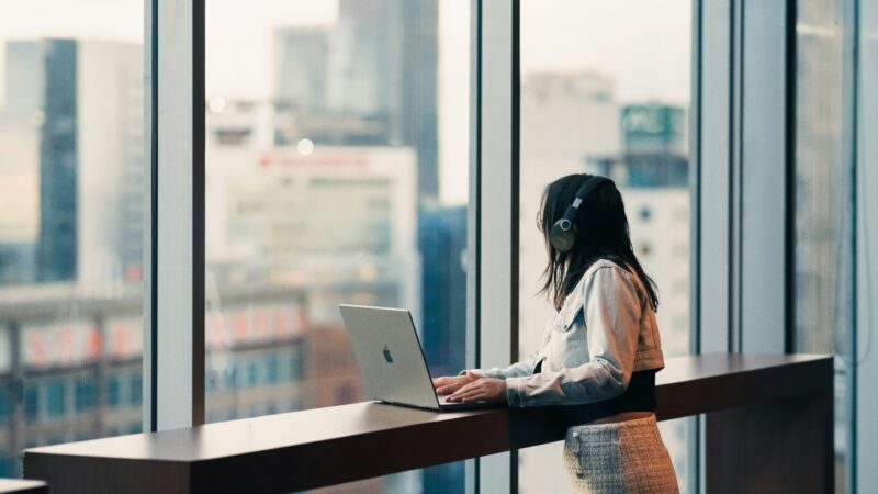 Tasks for AI: person reviewing AI-generated draft at a laptop before sending