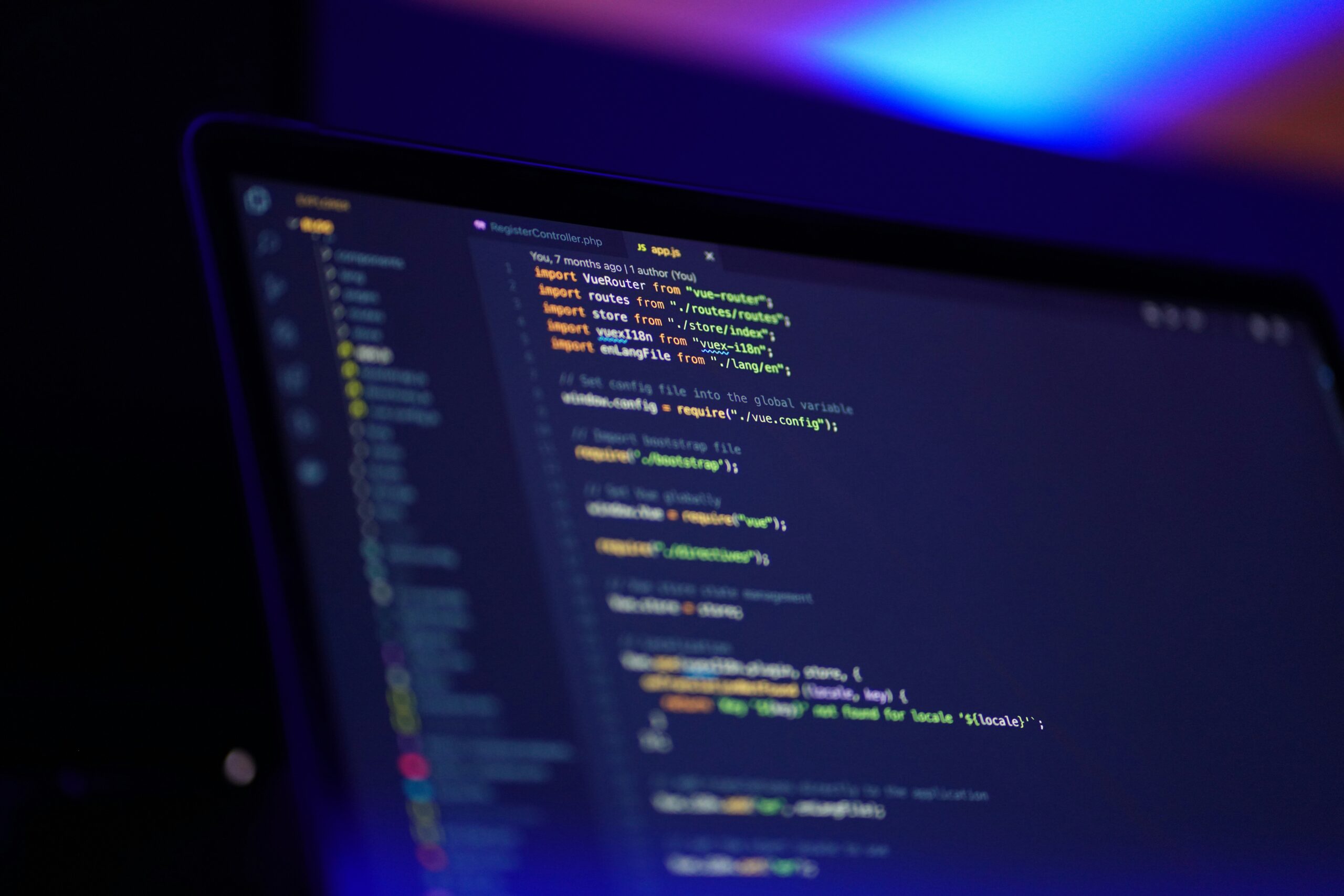 A developer working on software code on a laptop