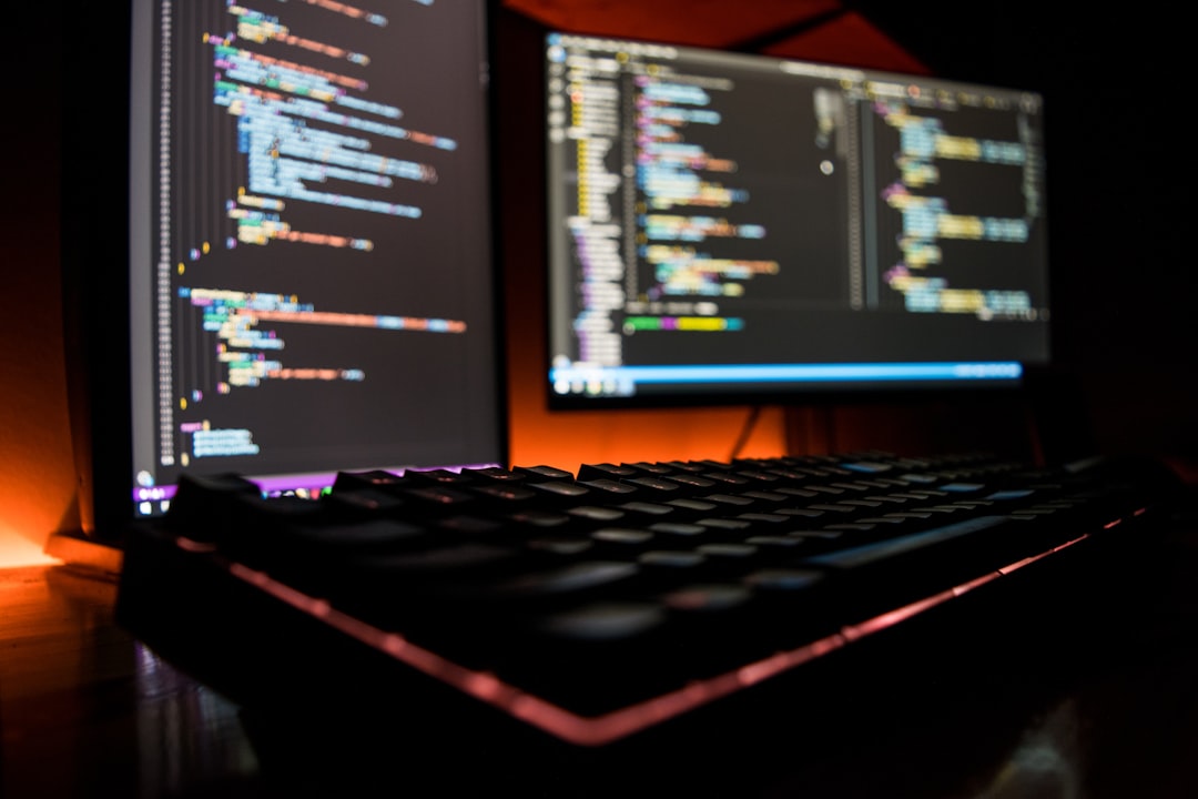 Developer working on a laptop with code on screen
