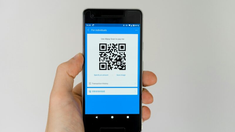QR code scams UK warning showing a fake QR code sticker placed over a legitimate payment sign