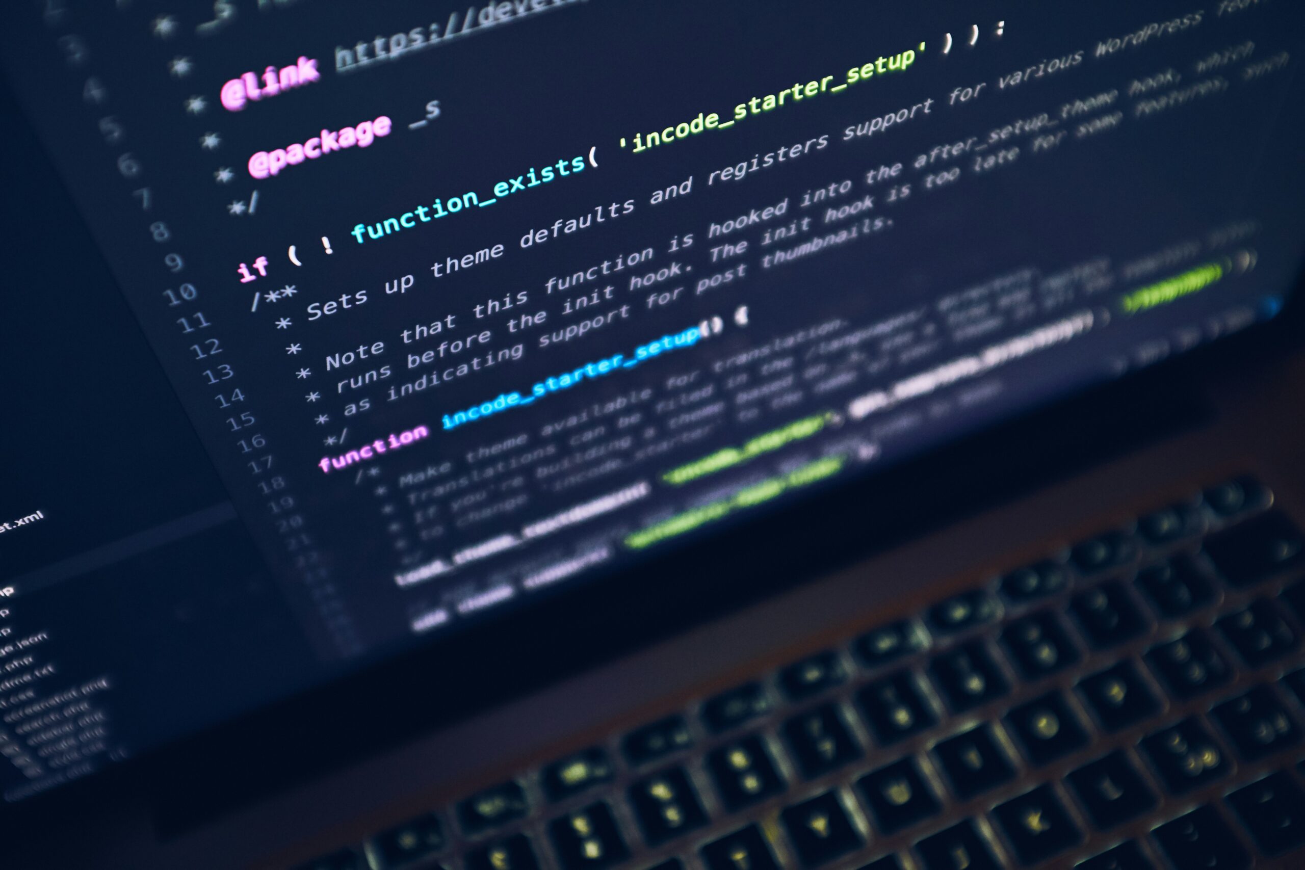 A developer working at a laptop in a software workspace