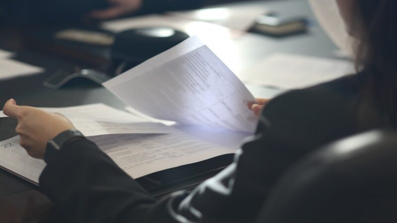 Worker reviewing notes to check if AI missed the point in a summary