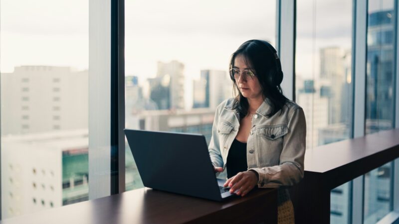 Small business owner using free AI tools on a laptop in a UK office
