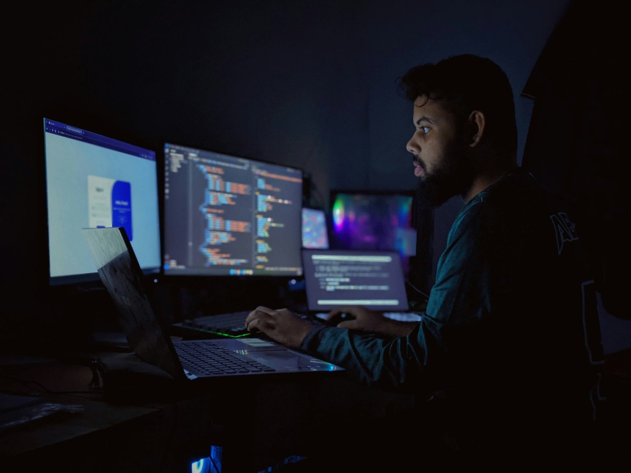 Developer working at laptop with code