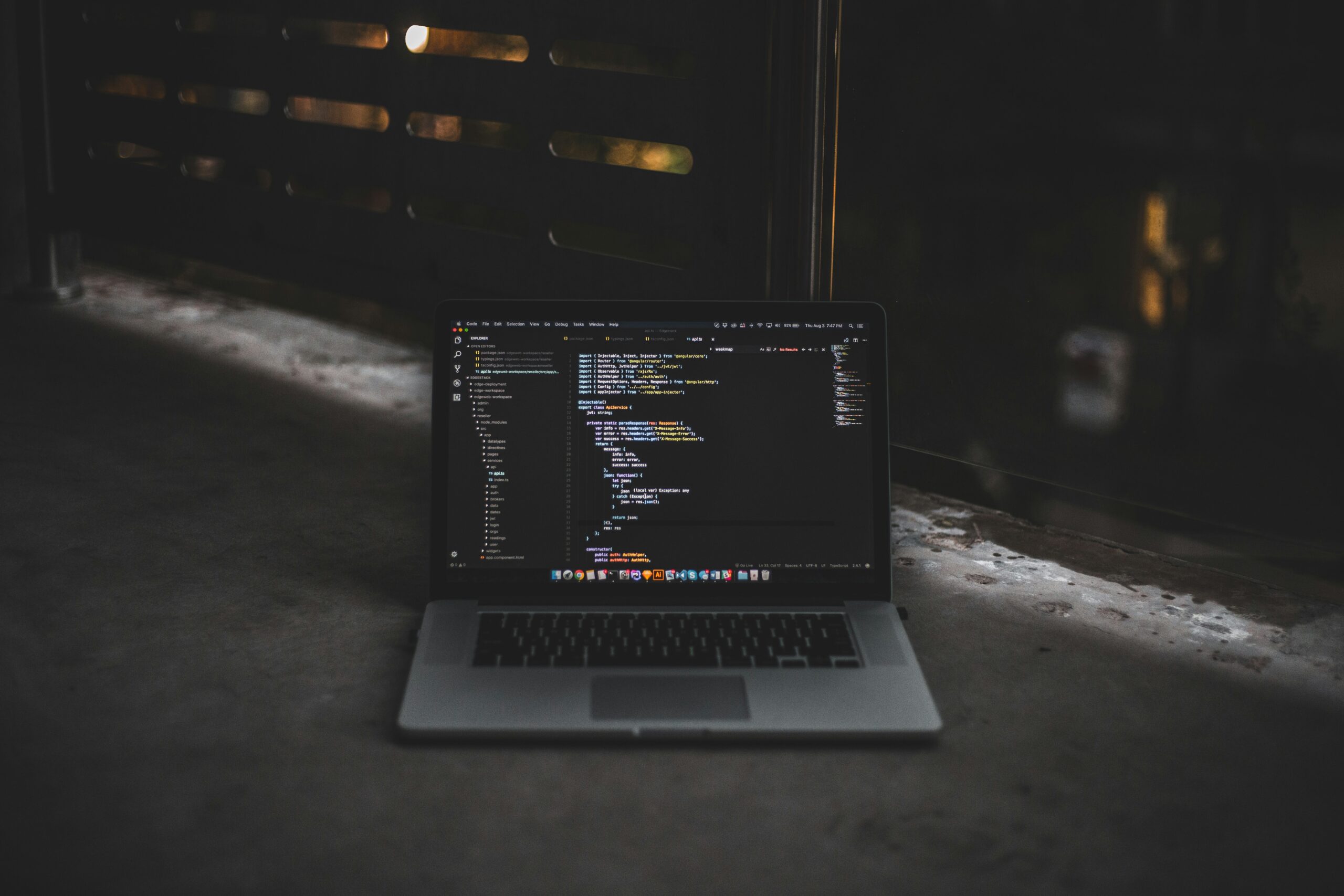 A developer workspace with a laptop and code on screen