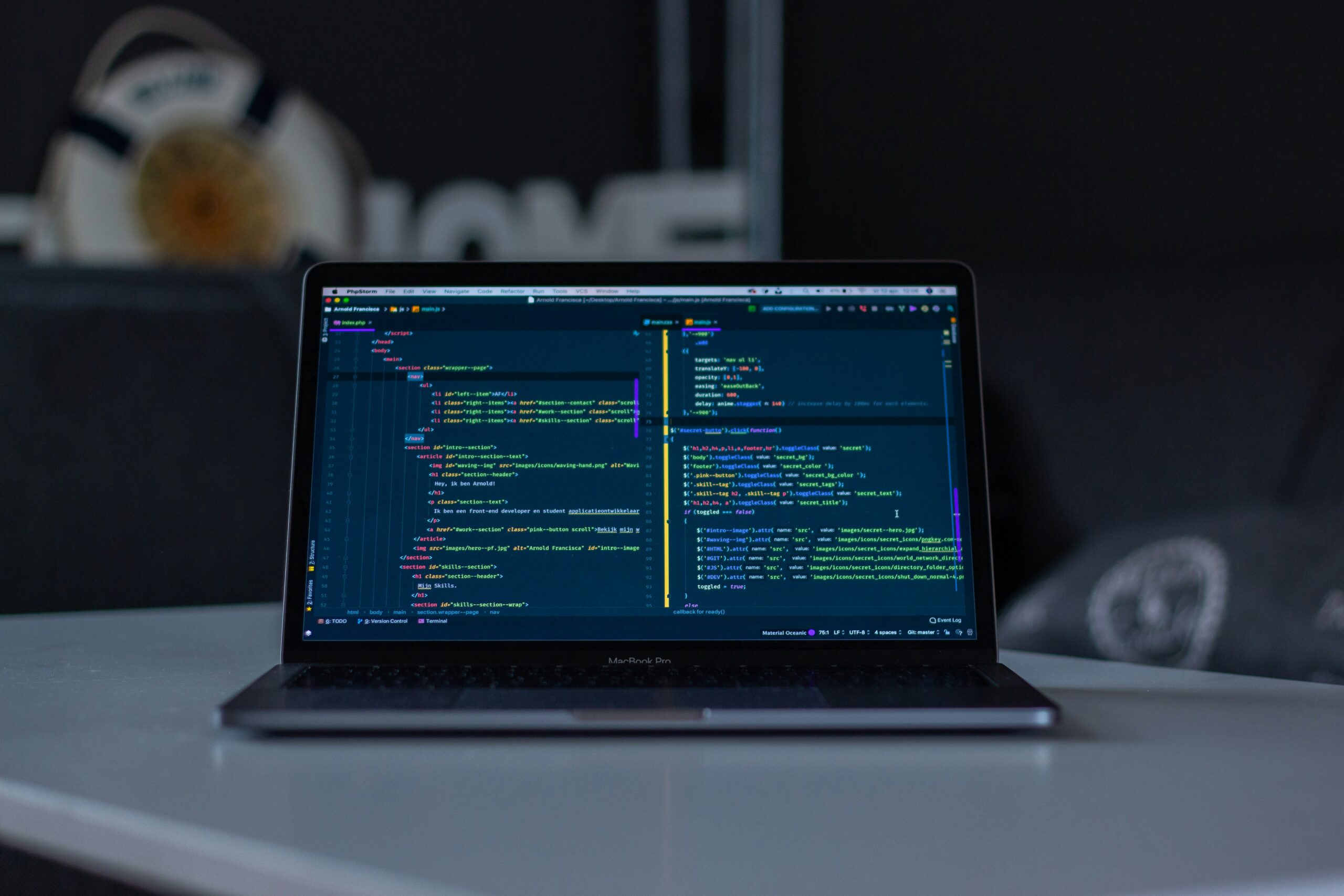 A developer workspace with laptop screens and software tools
