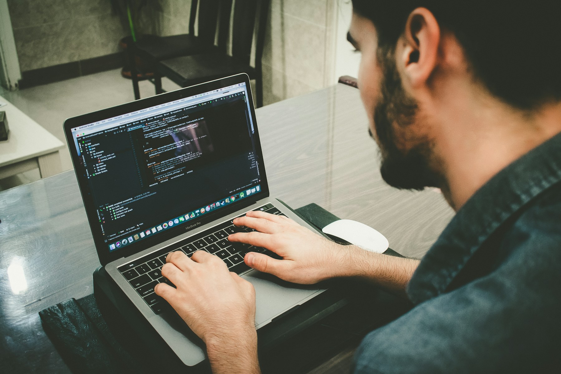 Developer workspace showing code and AI tools on a laptop