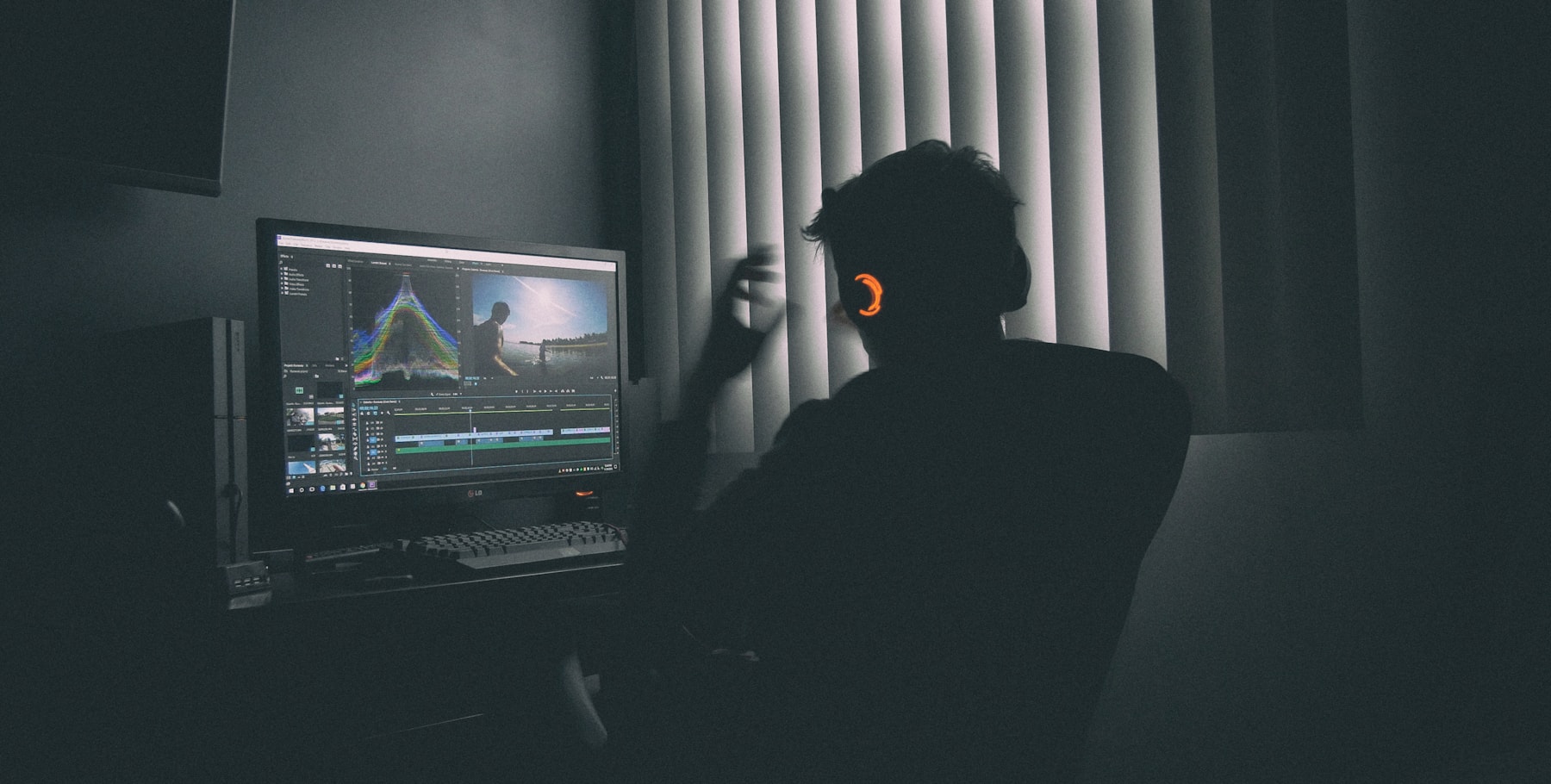Video editing workspace with a creator reviewing footage on a screen