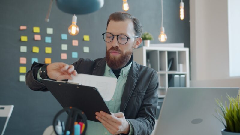 Worker reviewing an AI document summarisation on a laptop screen