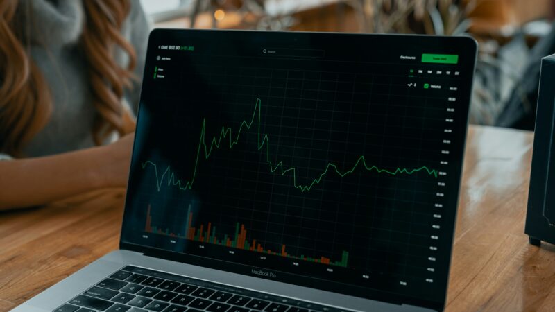 Share ramping: a stock chart spiking with coordinated forum posts and social media chatter overlaid