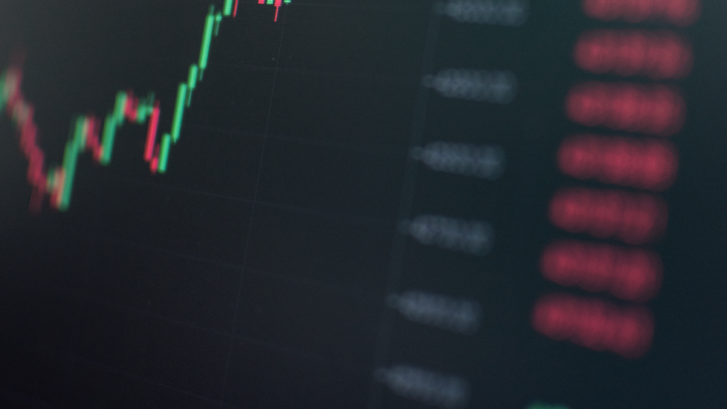 Rising green candlestick chart representing a surging IPO debut