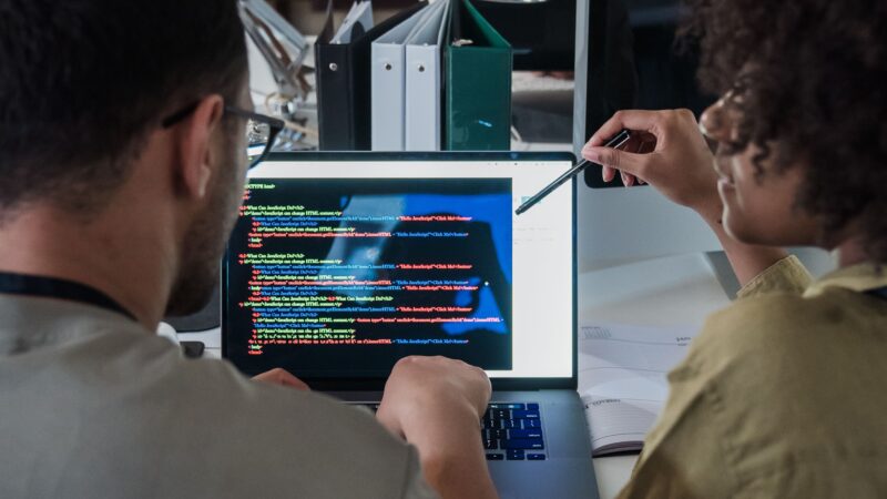 Developers reviewing code together, representing agent-driven software delivery