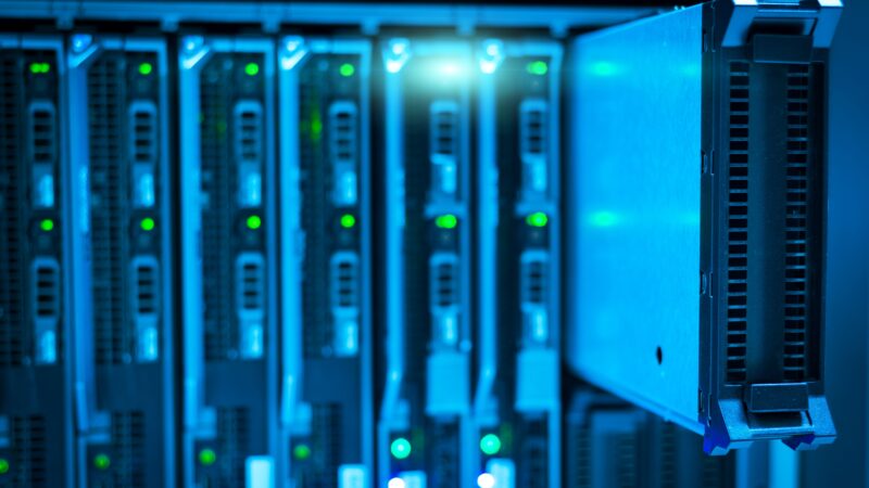Blue-lit data centre server racks representing cloud compute commitments