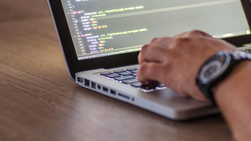 Developer typing code on a laptop, representing Claude Code