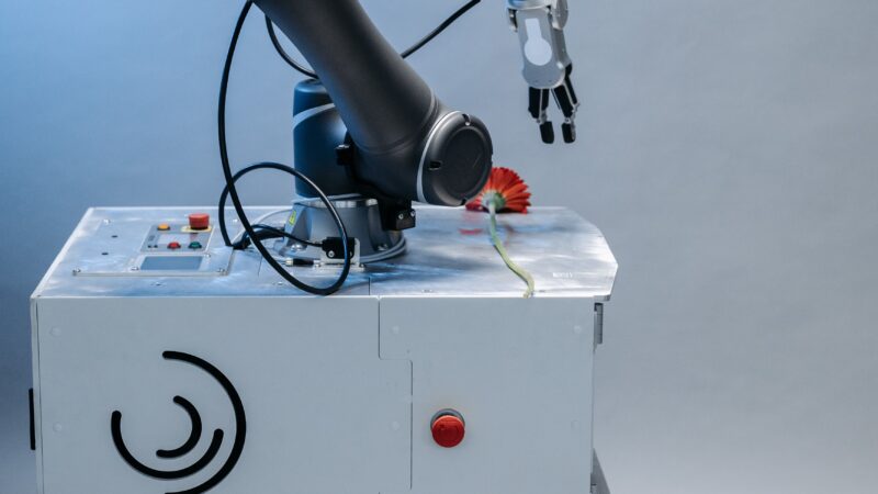 Robotic arm representing autonomous AI agents taking actions