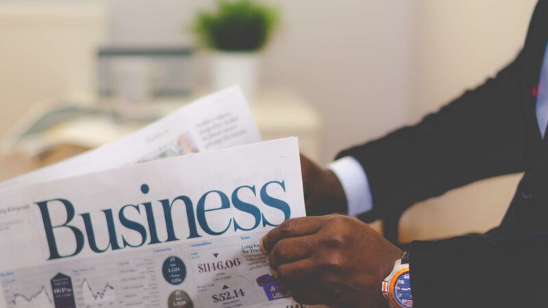 Reader holding a business newspaper, illustrating City phrases in financial news