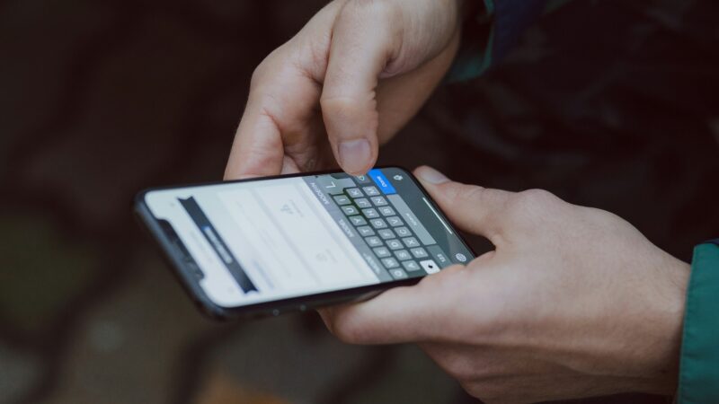 Person using a smartphone to review open banking app permissions.