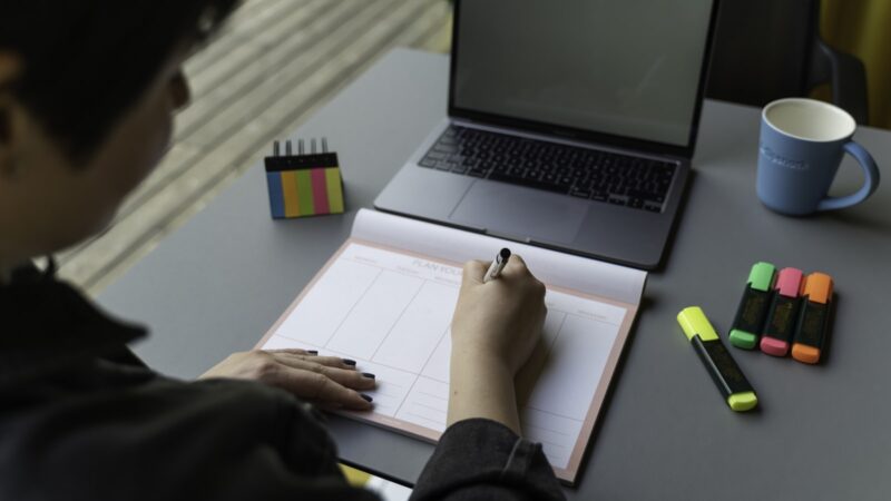 Colleague reviewing an AI-generated practice quiz on a laptop in an office setting.