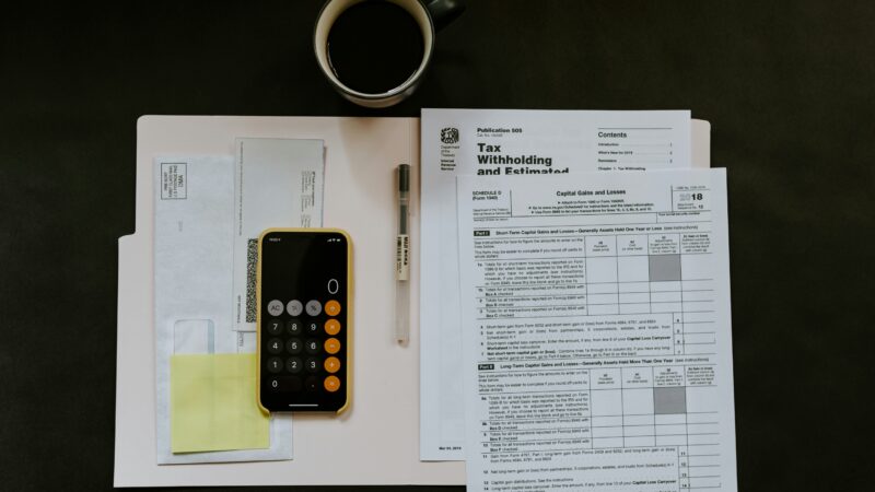 Phone, paperwork and financial documents illustrating a recovery-room scam follow-up call