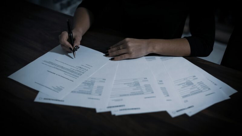 Investor reviewing documents before moving investments into an ISA tax wrapper
