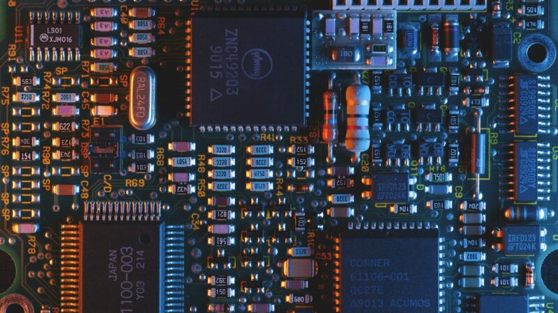 Close-up of a circuit board, used to illustrate AI model compression and efficient computing.