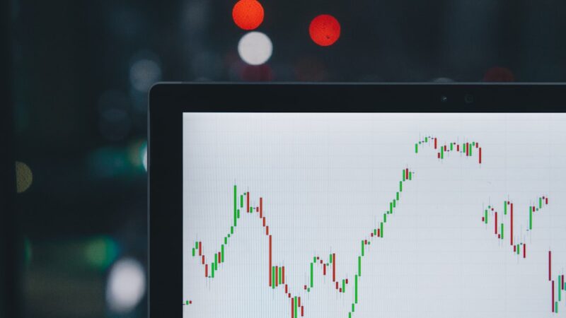 Stock lending short selling guide shown with a candlestick chart on a tablet screen