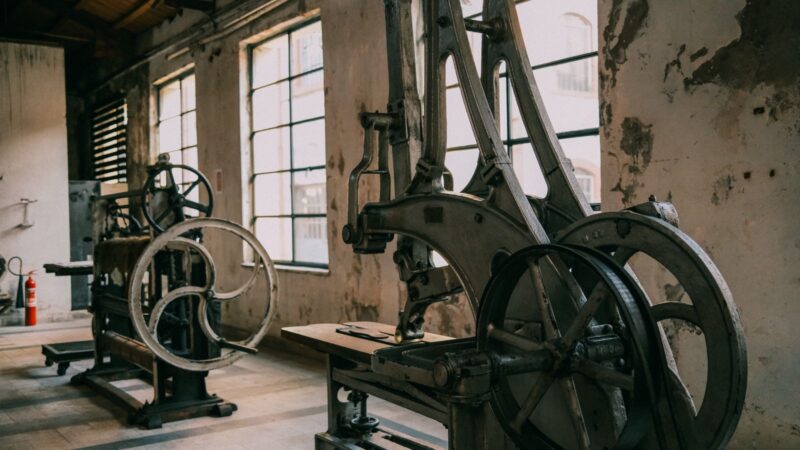 A view of vintage industrial machinery in an abandoned factory setting, emphasizing rustic charm.
