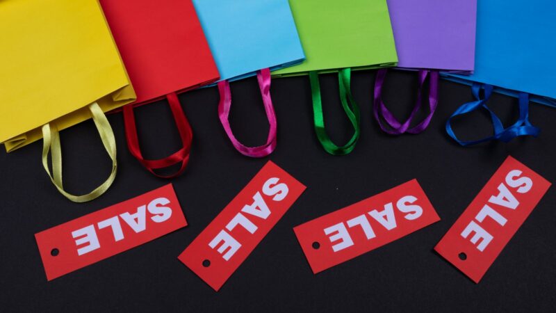 Colourful shopping bags with red price tags representing rising consumer prices